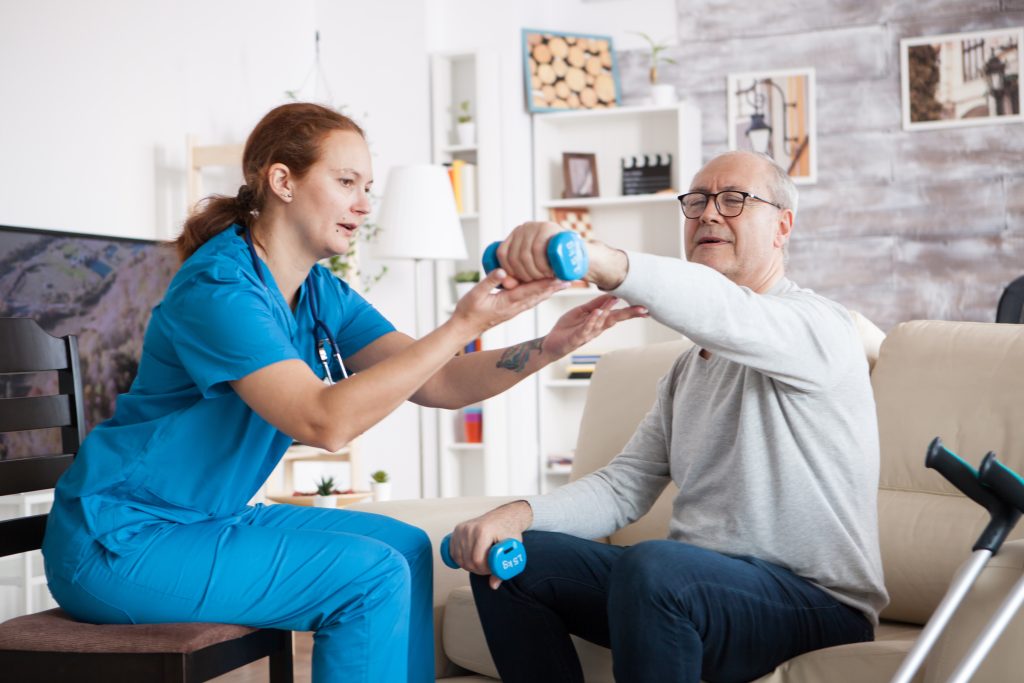 Physiotherapist assisting an elderly person with balance exercises